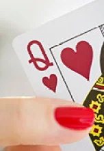 Hand holding a queen of hearts card